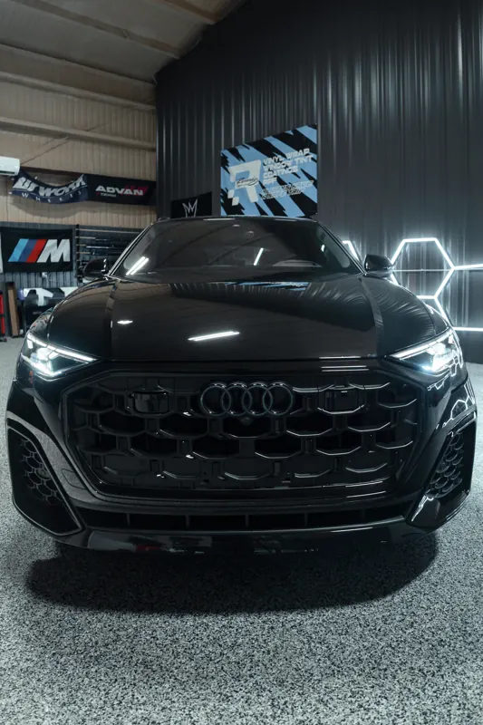 Blacked-out Audi Q8 front grille under hex lights