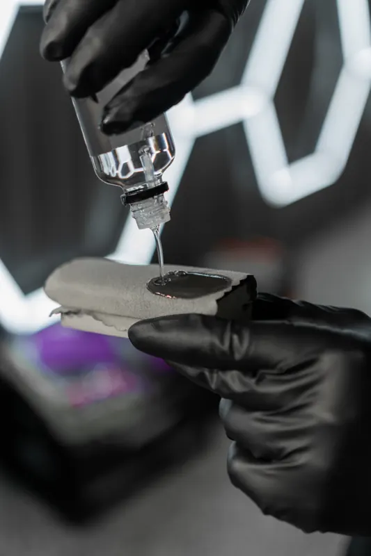 Ceramic coating being dropped onto an applicator pad